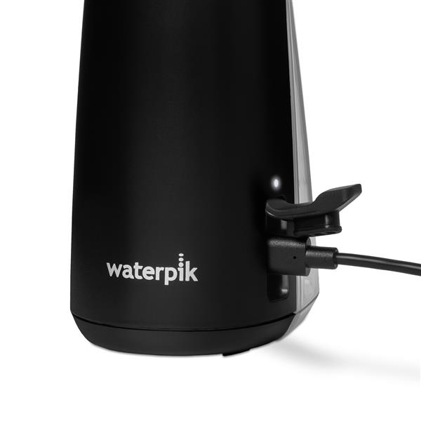 Charging port on the base of the Black Cordless Plus 5000 handheld water flosser.