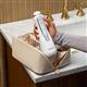 White Cordless Advanced 2.0 handheld water flosser, without tip, taken out of a toiletry bag.