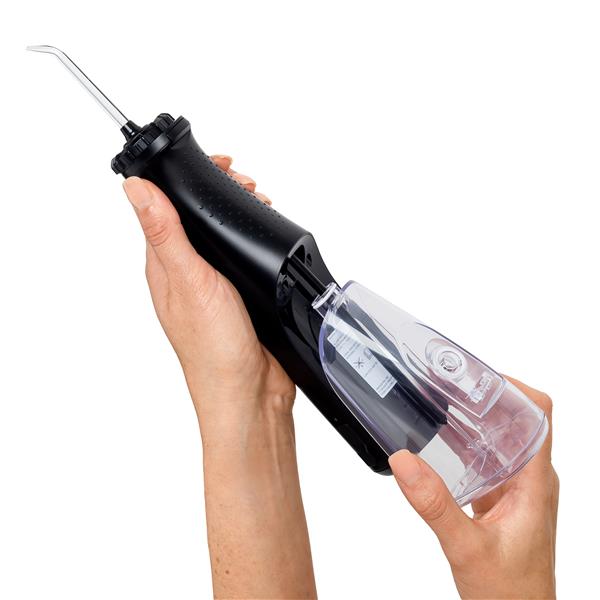 Sliding the water reservoir to remove it from the Black Cordless Plus 5000 water flosser handle.