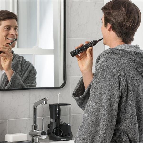 Using Black Complete Care 5.0 Toothbrush
