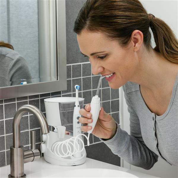 Using White Complete Care 5.5 Water Flosser Toothbrush