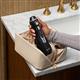 Black Cordless Advanced 2.0 handheld water flosser, without tip, taken out of a toiletry bag.